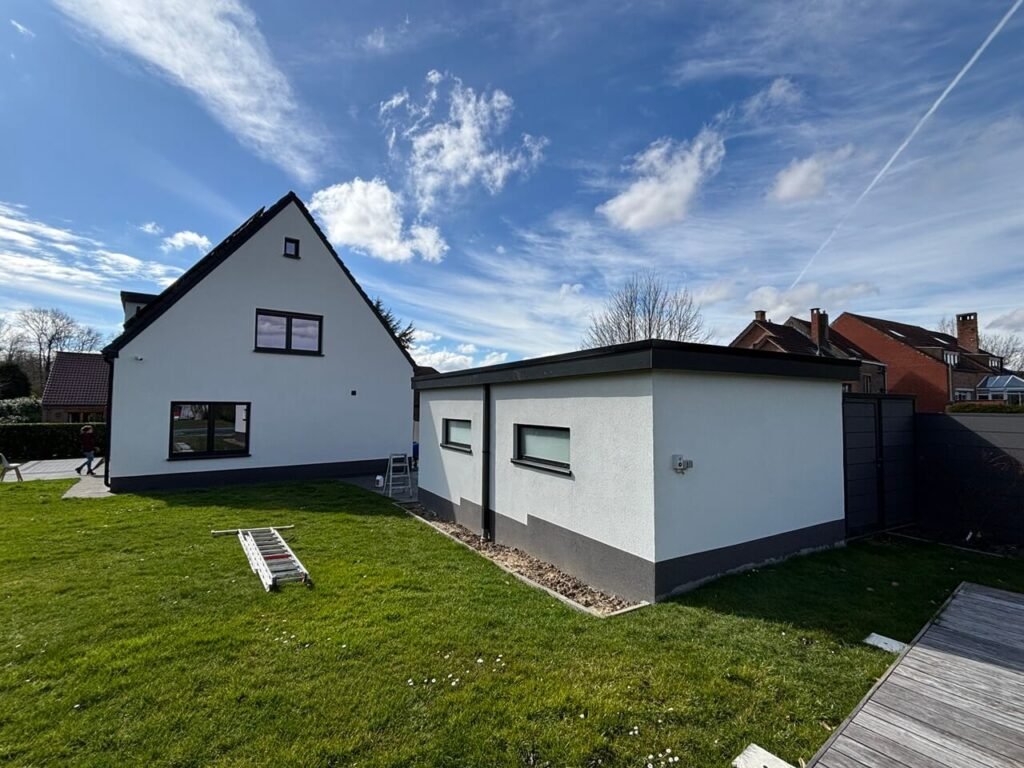 Maison terminée avec isolation thermique extérieure, incluant un garage attenant, façade propre et finie.